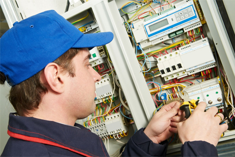 Man in blue hat changing fuses
